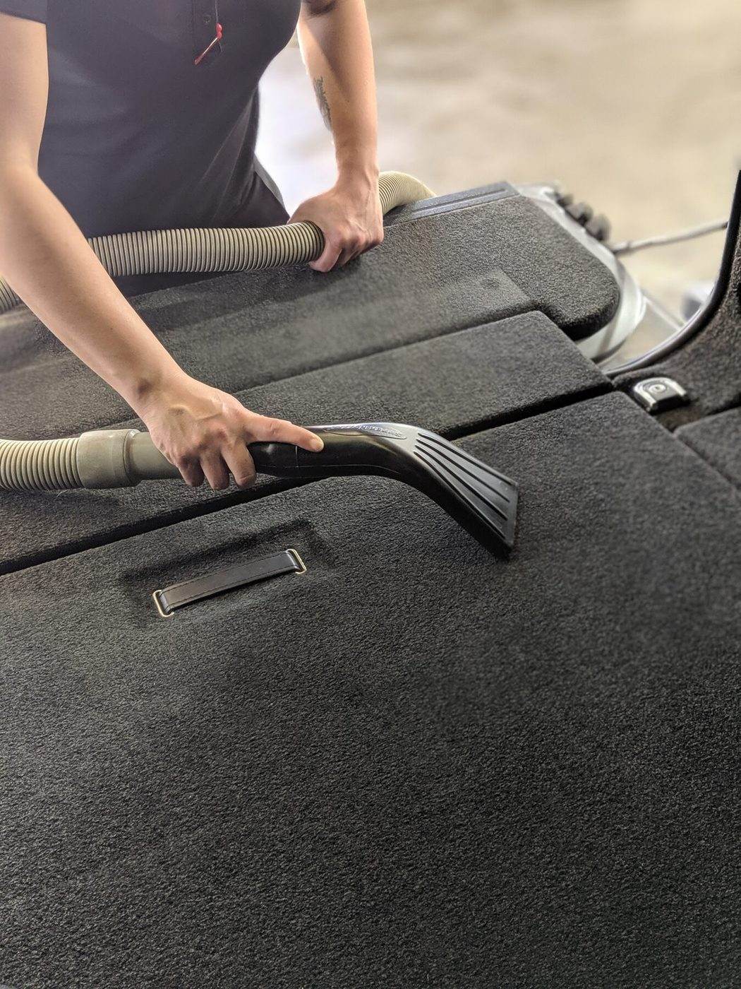 Technician cleaning vehicle interior